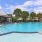 a swimming pool with umbrellas and chairs